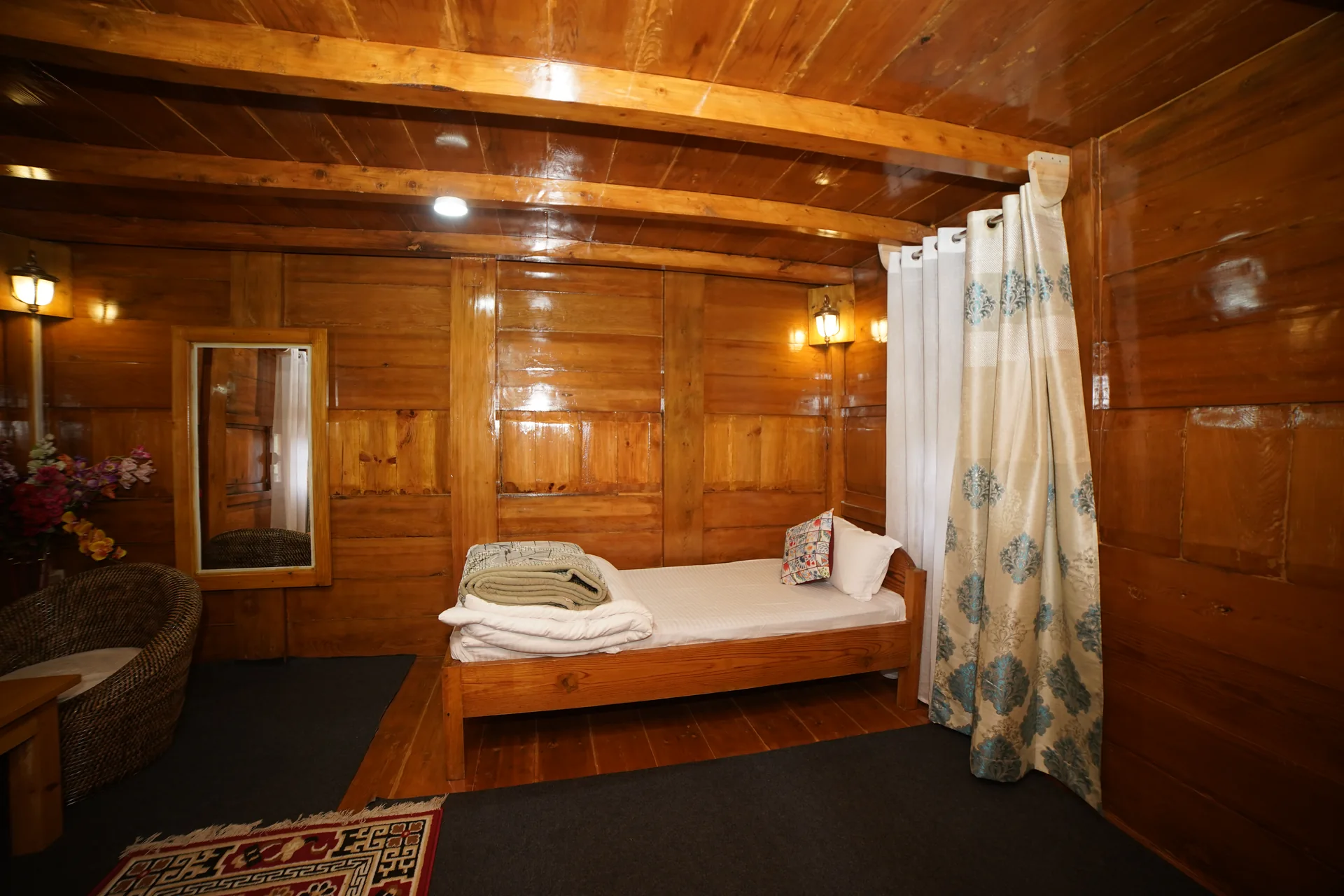 Single bed wooden panel room at Acorn Homestay Shergaon